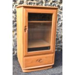A vintage Ercol Windsor range light elm hi-fi cabinet, having a single bevelled glazed door,