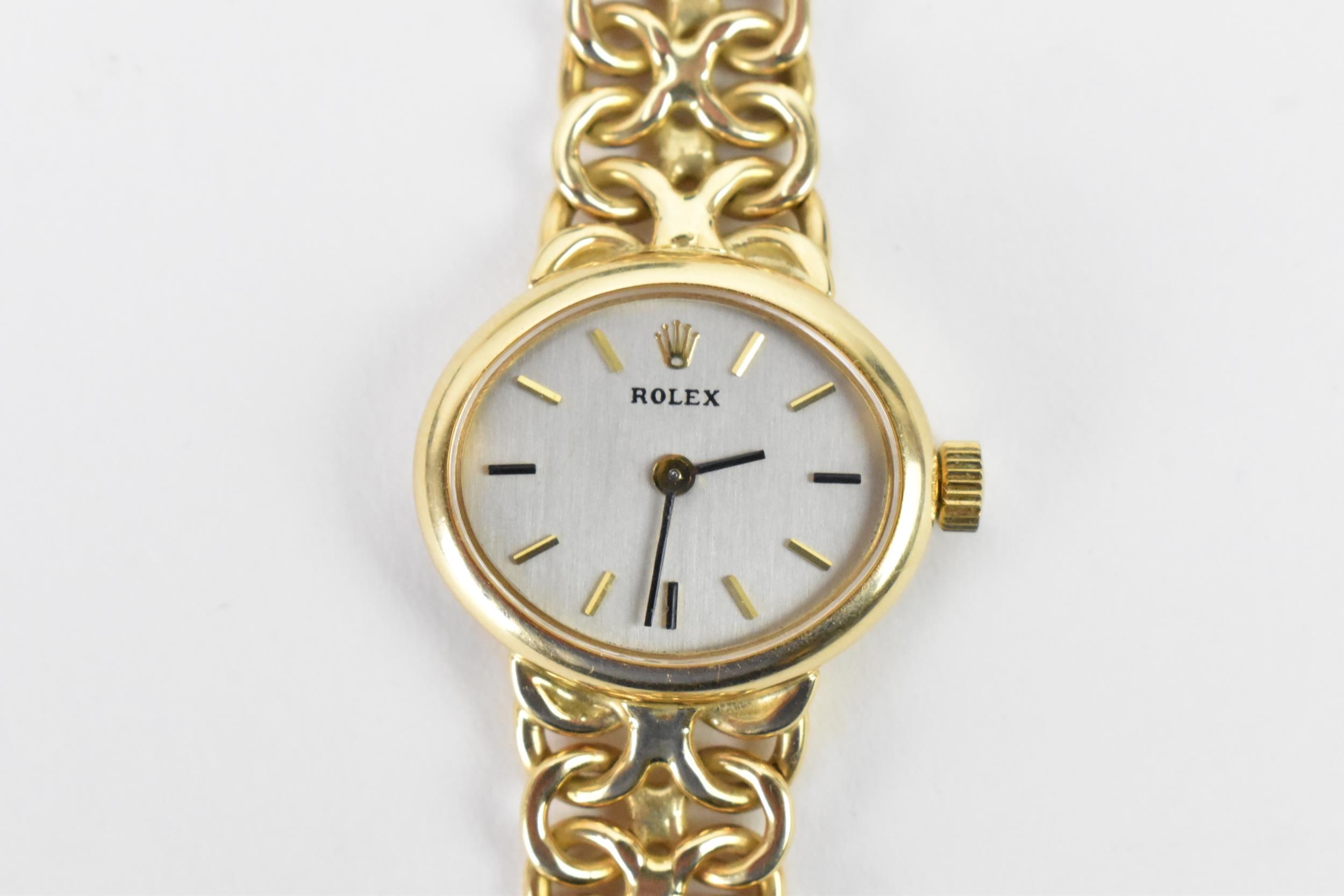 A Rolex, manual wind, ladies, 14ct gold dress watch, circa 1993, having a oval silvered dial,