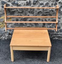 A vintage Ercol Windsor range light elm and beech square topped coffee table, raised on four