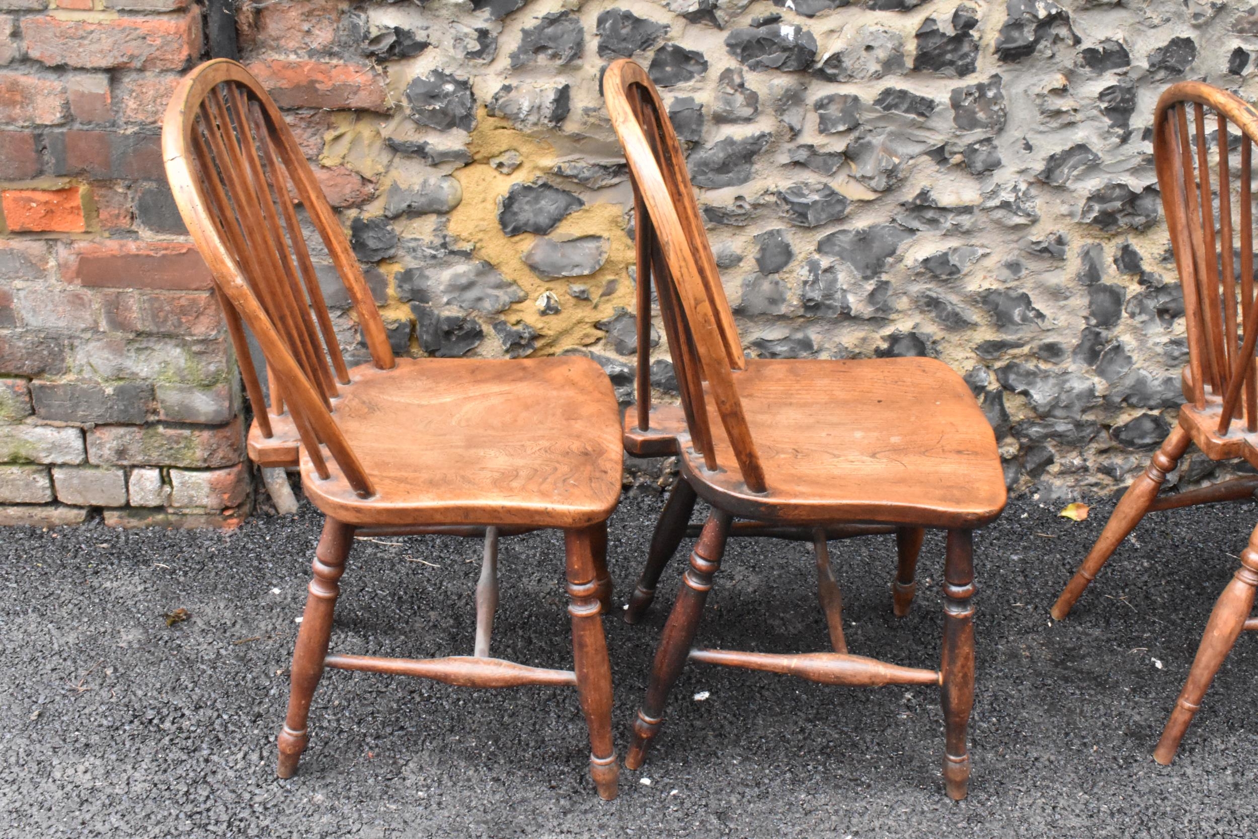 A set of four 19th century elm and ash Windsor dining chairs, having spindle hoop shaped backs, - Image 9 of 10