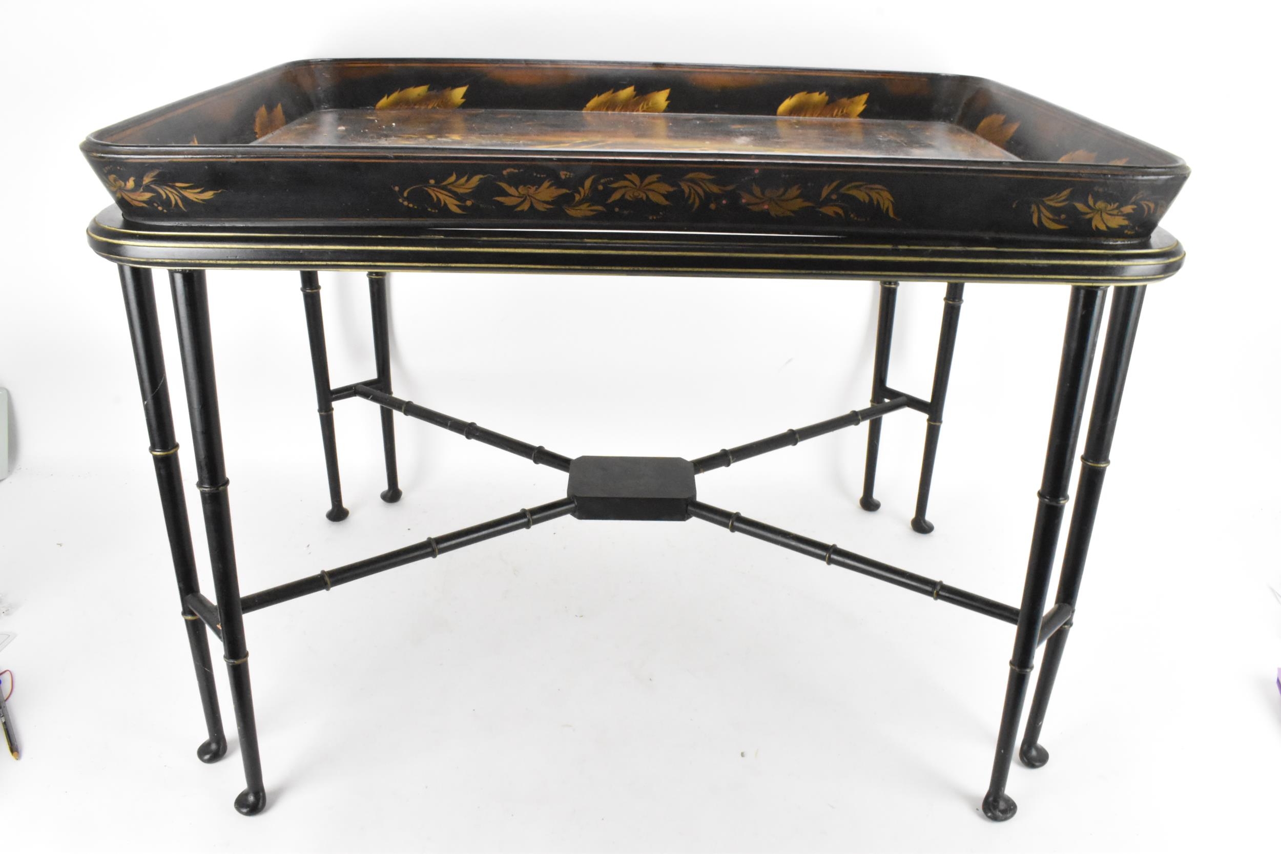 A tray top table having a Victorian black lacquered papier mache tray with a floral border enclosing - Image 4 of 4