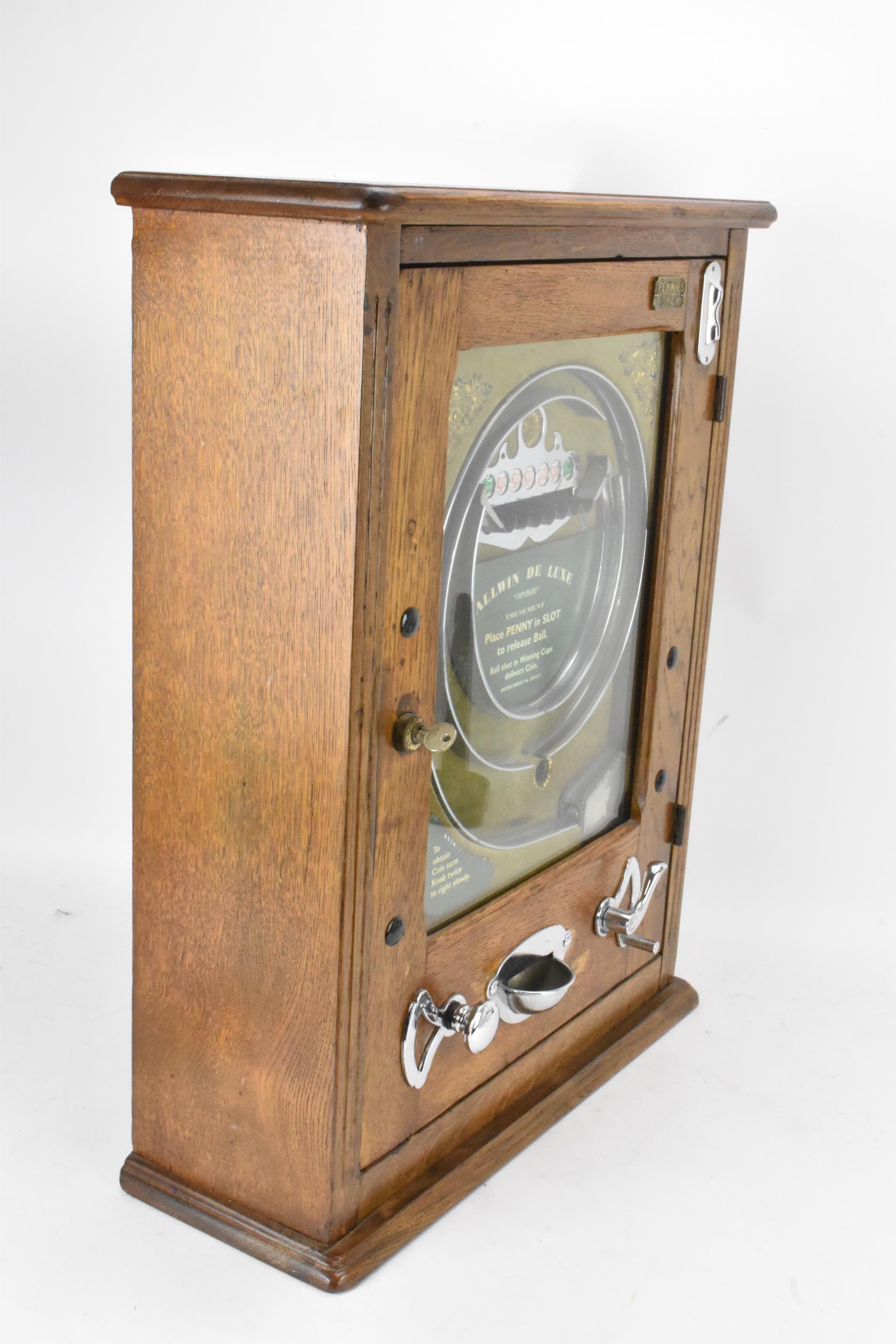 An Allwin De Luxe oak cased penny slot machine, circa 1920, with internal metal ball track, - Image 11 of 12