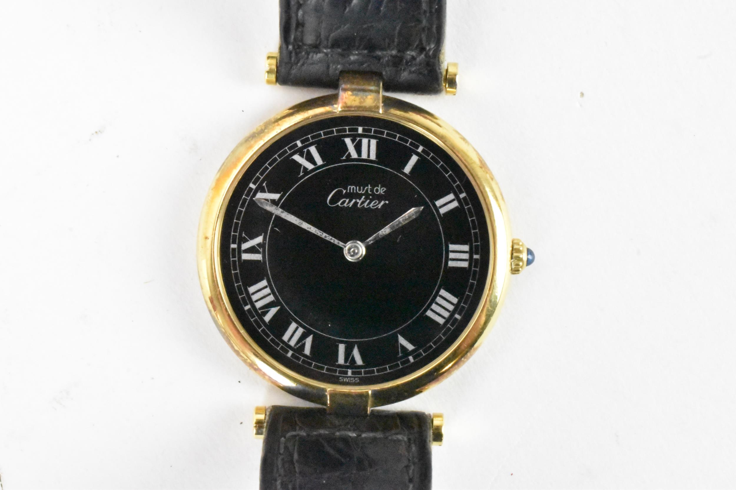 A must de Cartier, quartz, ladies, silver gilt wristwatch, having a black dial with Roman