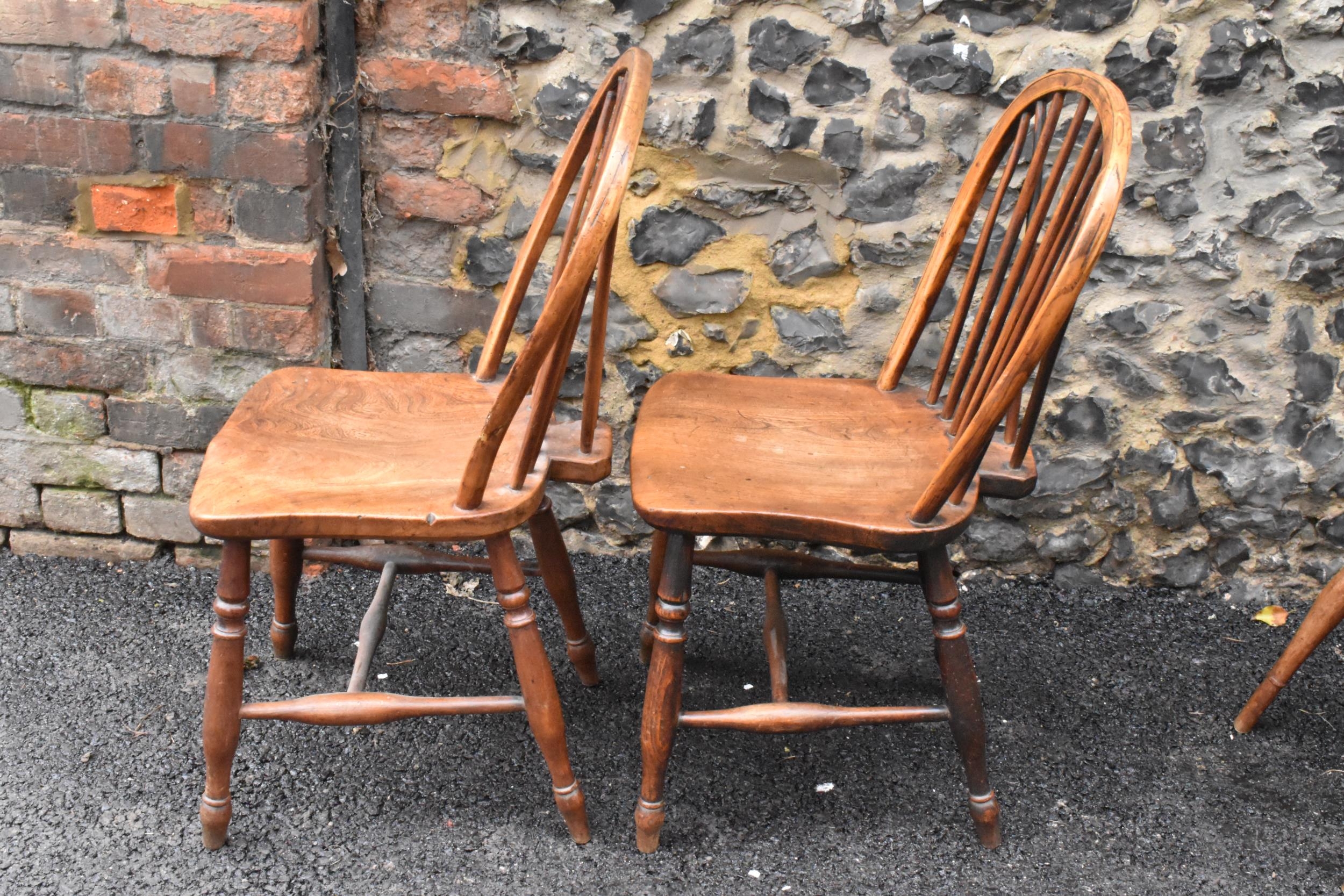 A set of four 19th century elm and ash Windsor dining chairs, having spindle hoop shaped backs, - Image 7 of 10