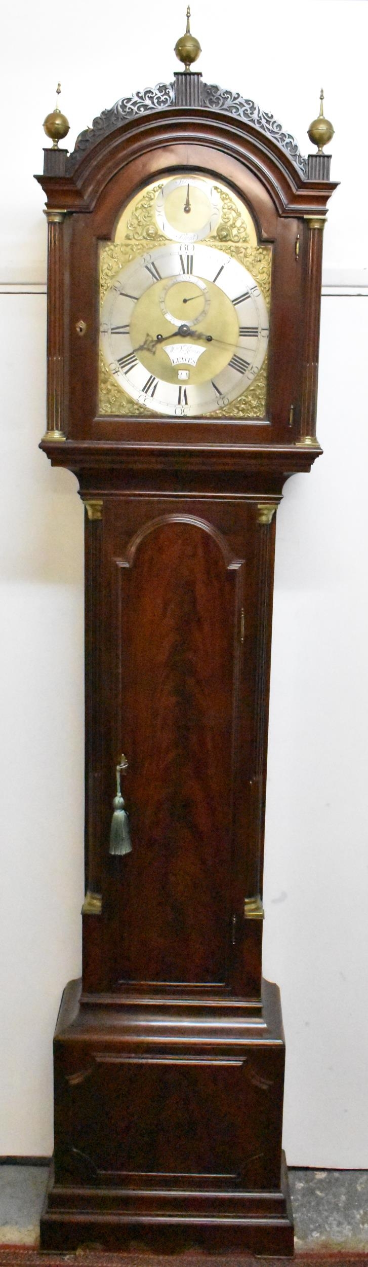 A George III mahogany longcase clock, the case having an arched top with three ball and spike