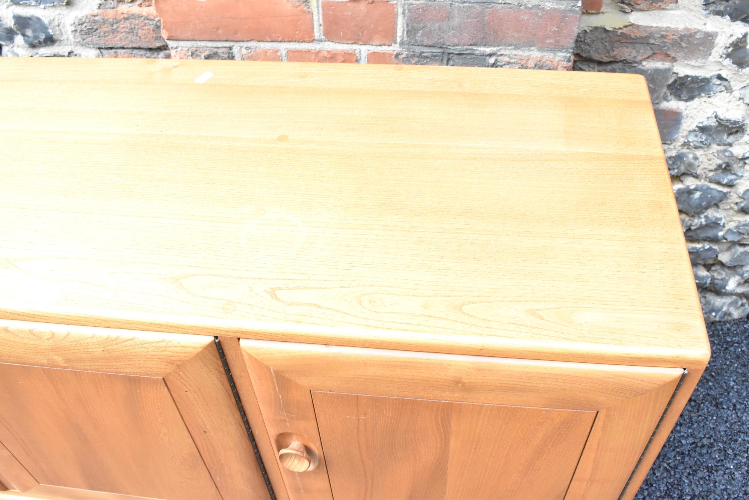 A mid 20th century Ercol Windsor range light elm sideboard, mode 468, having three cupboard doors - Image 3 of 6