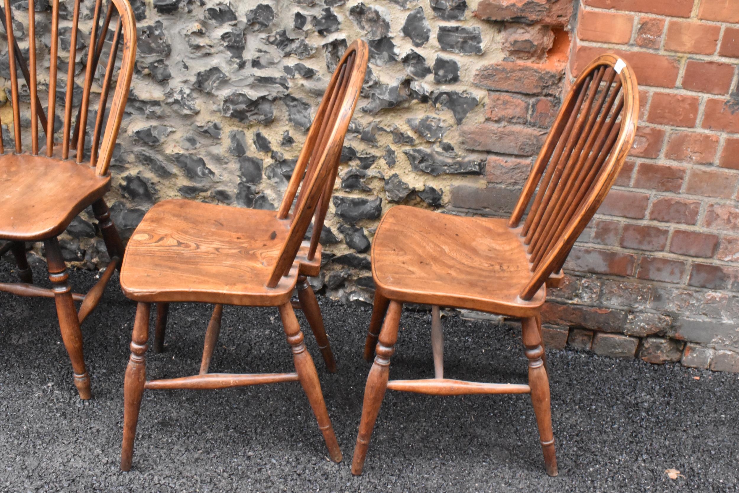 A set of four 19th century elm and ash Windsor dining chairs, having spindle hoop shaped backs, - Image 3 of 10
