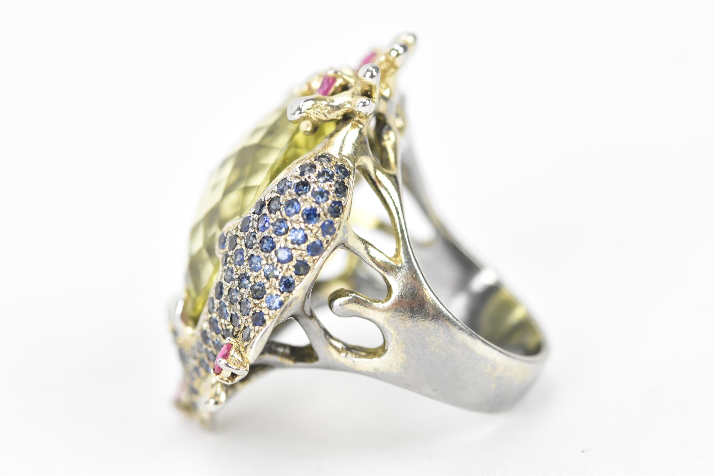 A silver dress ring inset with a large lemon quartz to the centre, decorated with a dolphin and - Image 2 of 3