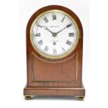 A 19th century mahogany bracket clock, the case having an arched top with gilt pierced side