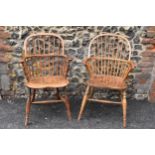 A pair of 19th century elm and ash Windsor carver dining chairs, having spindle hoop shaped backs,