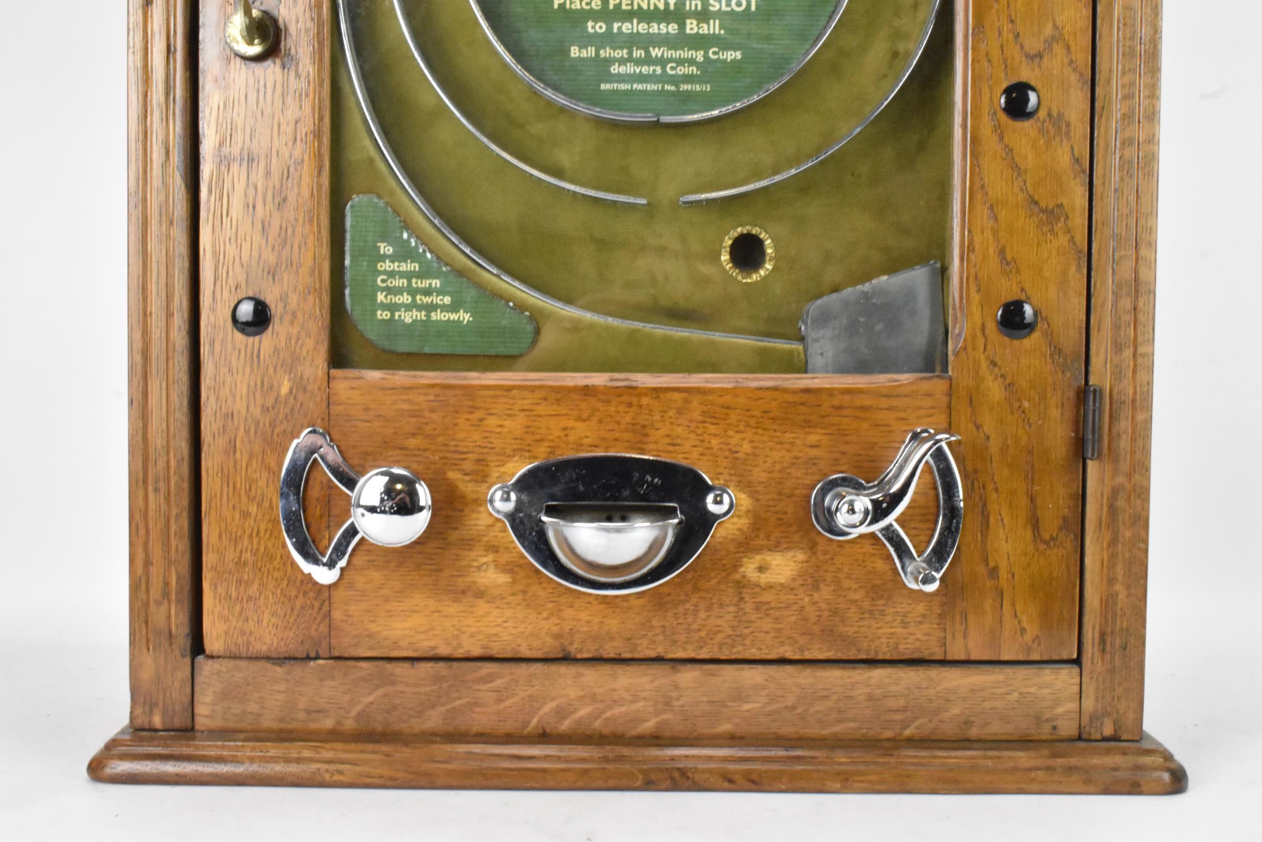 An Allwin De Luxe oak cased penny slot machine, circa 1920, with internal metal ball track, - Image 5 of 12