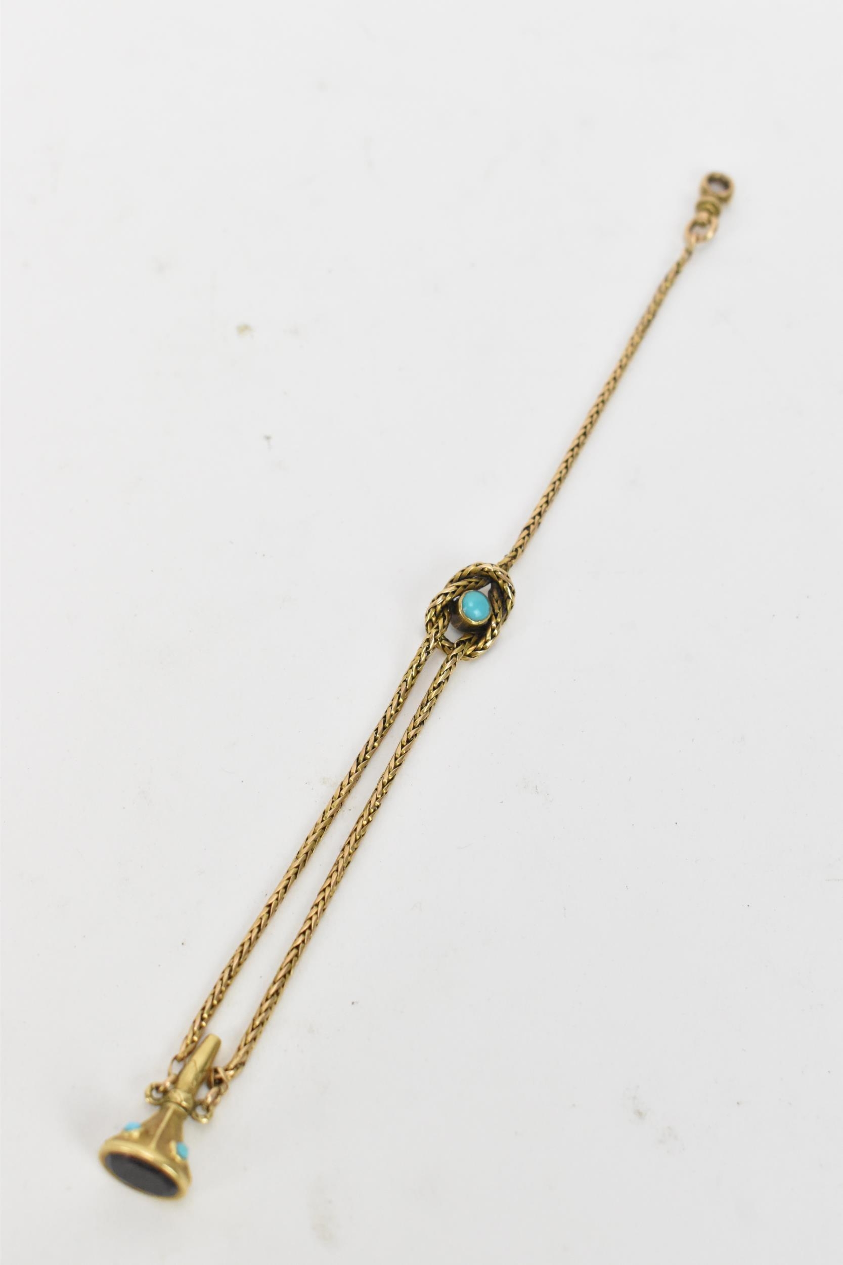 A Victorian yellow metal watch chain, the centre of the chain having a central turquoise