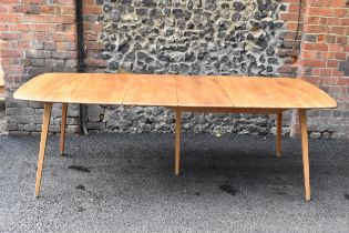 A vintage Ercol elm and beech extending dining table with one folding leaf, on four splayed square