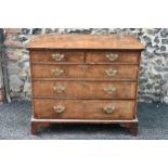 A circa 1700 walnut chest of drawers, having a quarter cut veneered and cross banded top, two