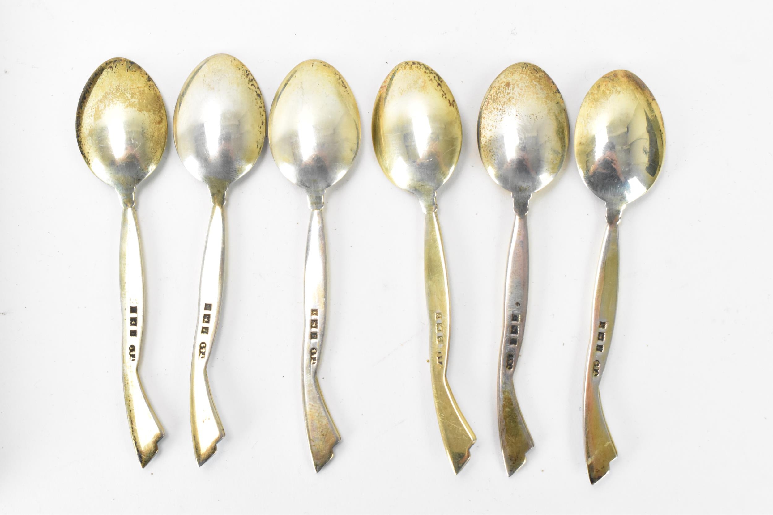 A cased set of six mid 20th century coffee bean spoons, retailed by Harrods, all having guilloche - Image 4 of 6