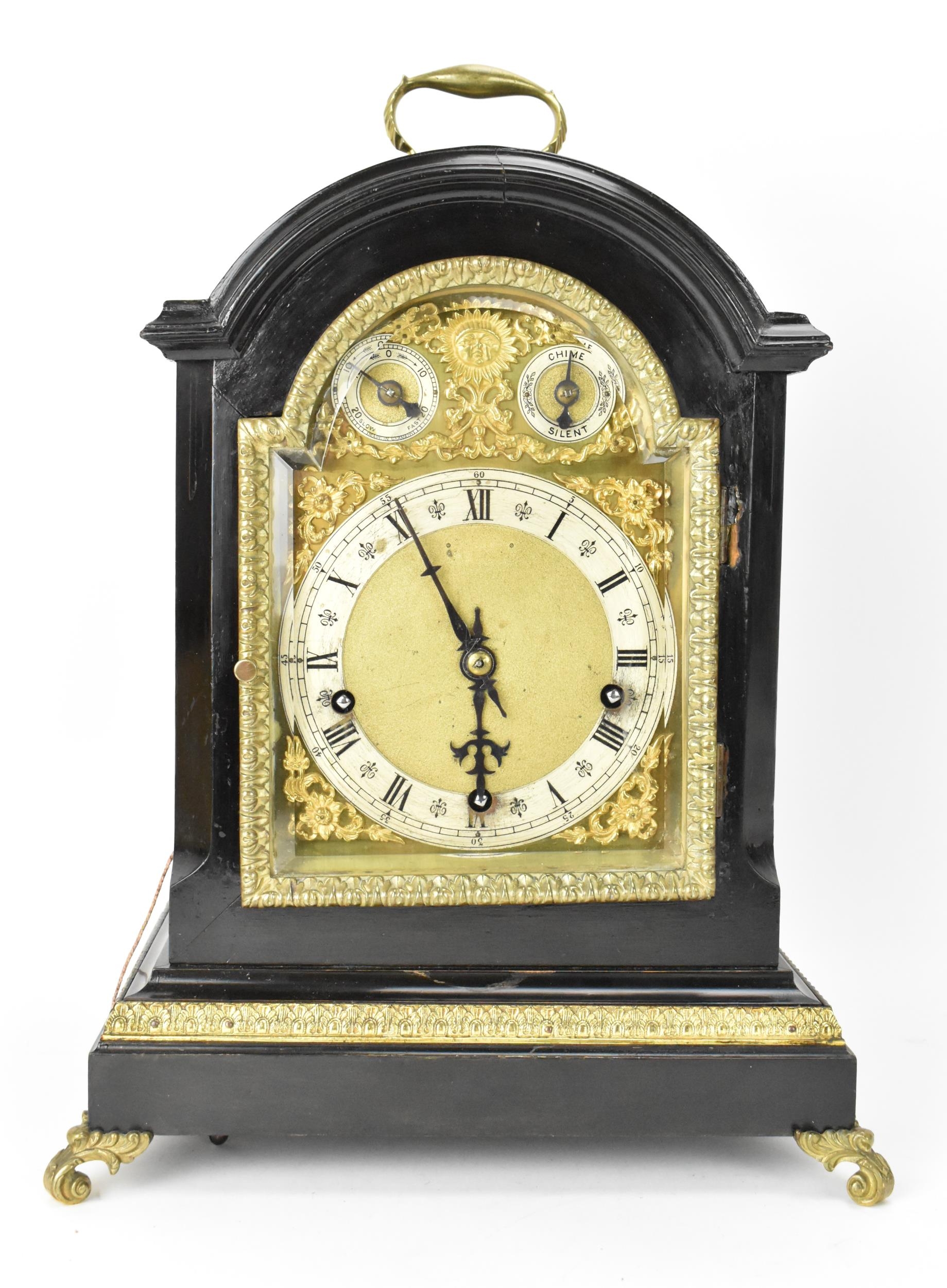 A late 19th century Winterhalder & Hofmeier ebonised mantle clock, the arched top case having cast
