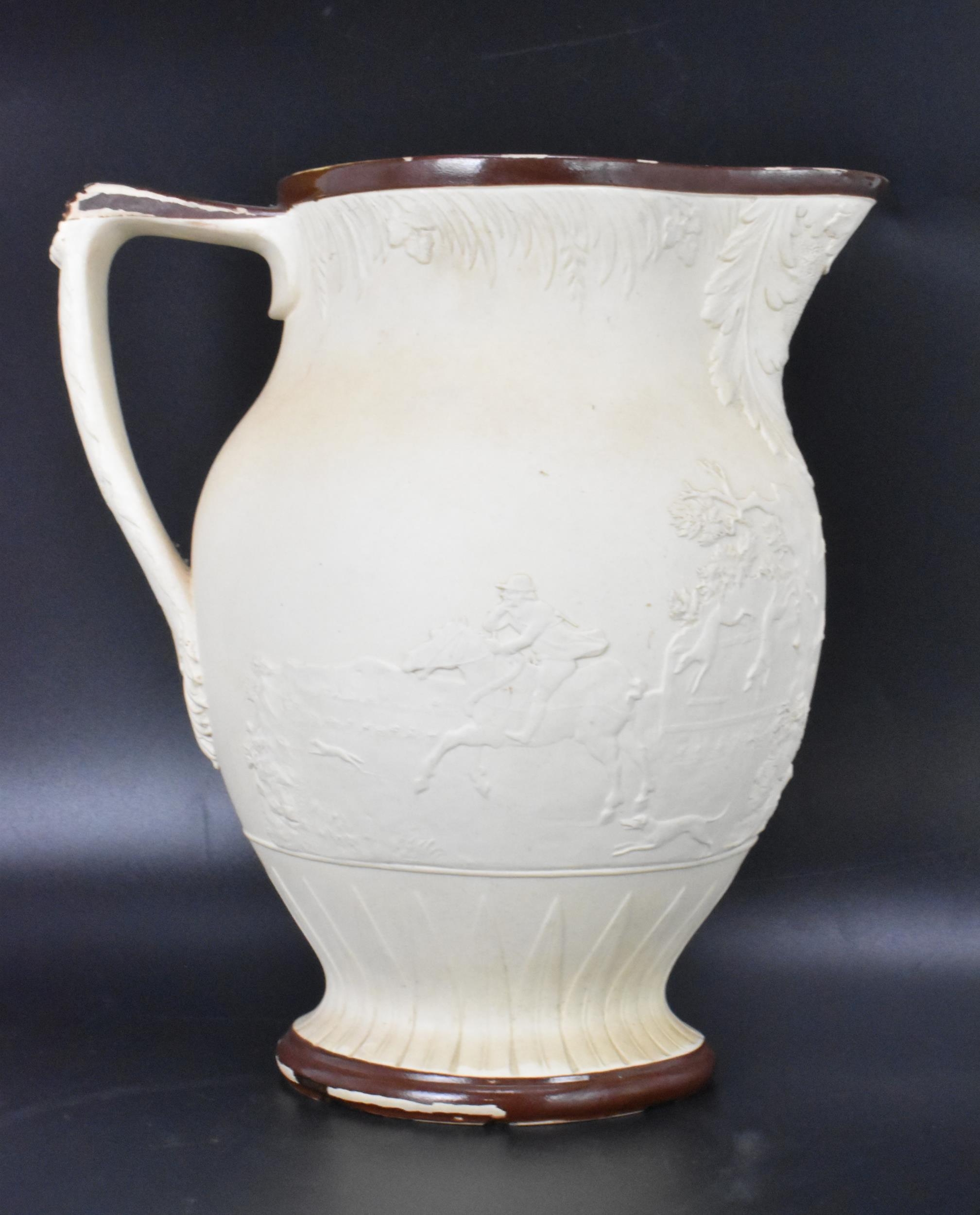 A circa 1800 Turner stoneware jug, moulded decoration depicting a hunting scene and with brown