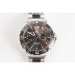 A Tag Heuer Formula 1, quartz, alarm, gents, stainless steel wristwatch, having a black dial, two