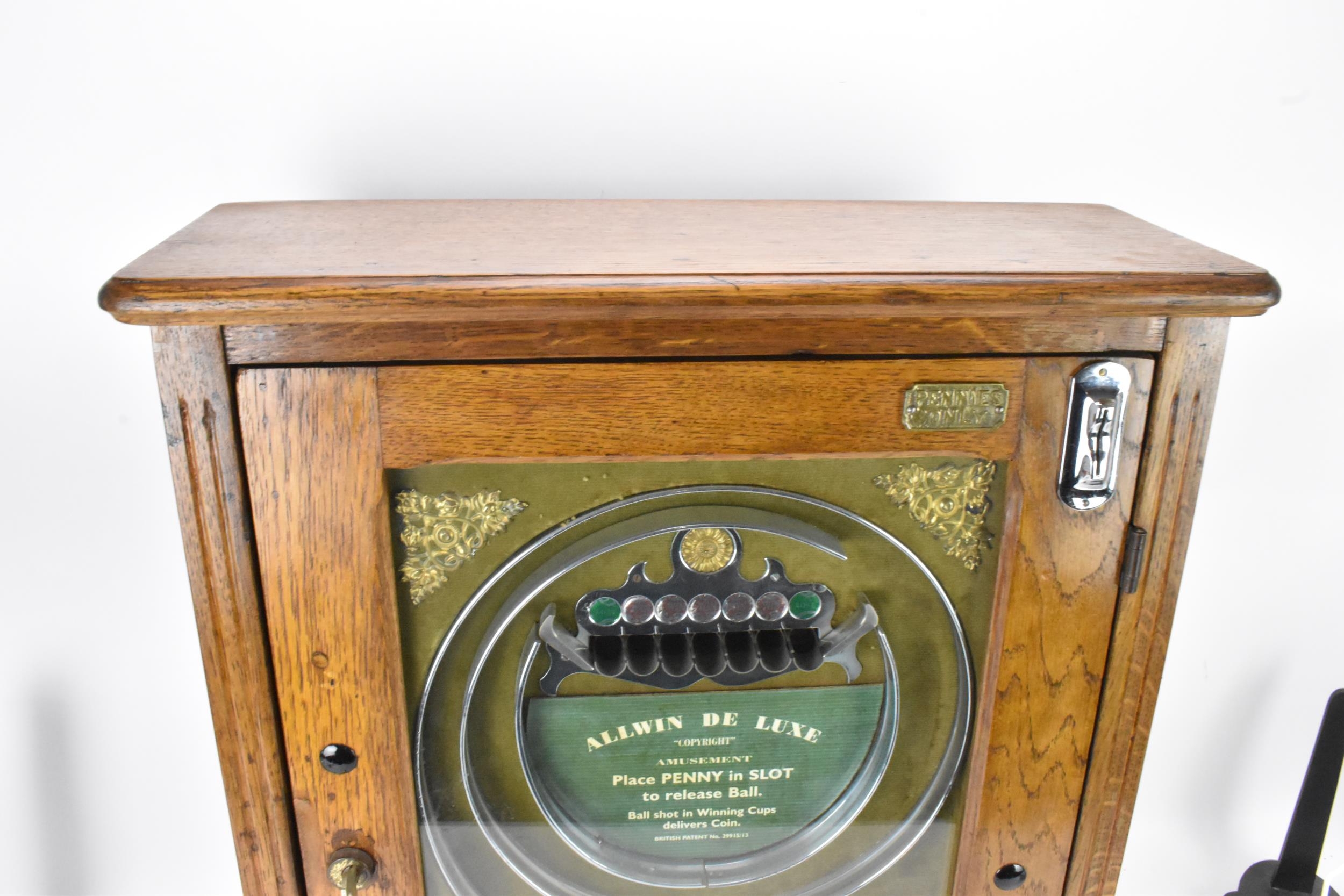 An Allwin De Luxe oak cased penny slot machine, circa 1920, with internal metal ball track, - Image 2 of 12