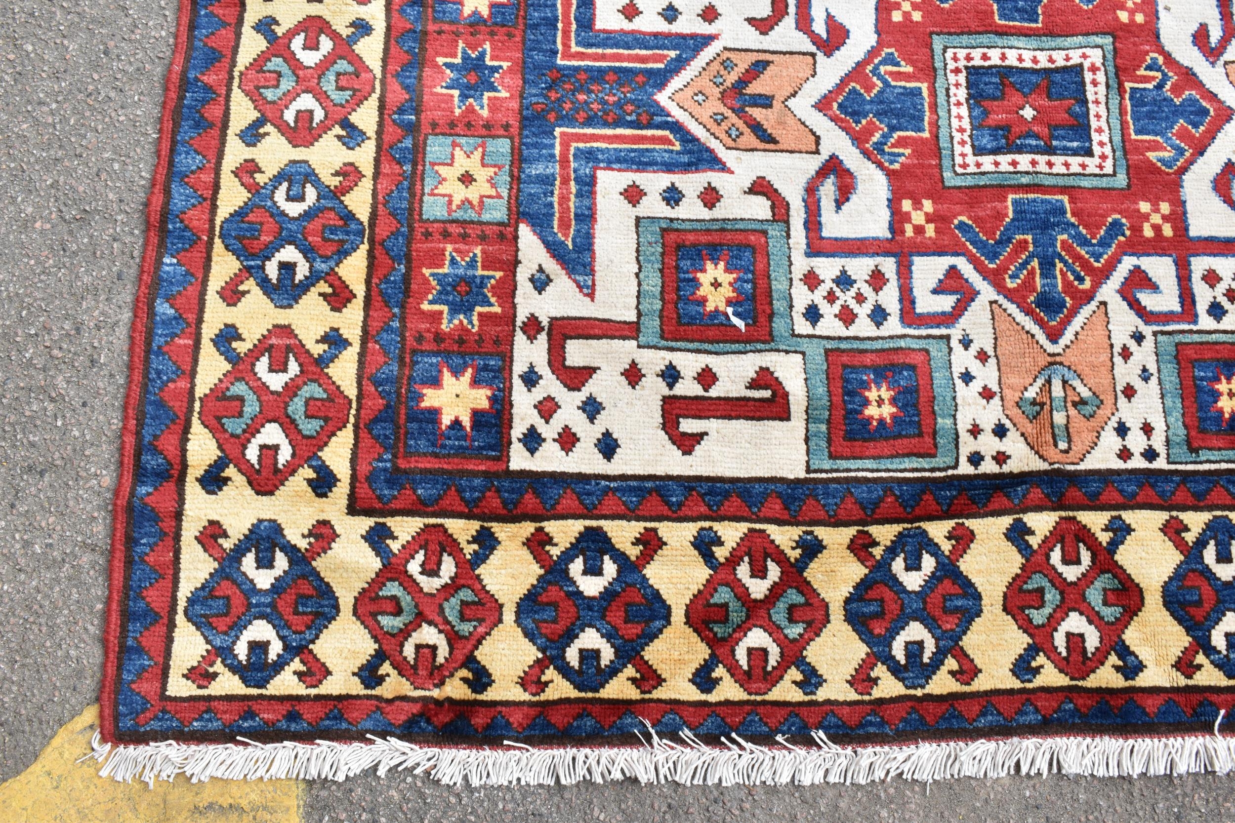 A handwoven Caucasian star kazak rug, having a geometric designs with repeating motifs, multiguard - Image 7 of 8