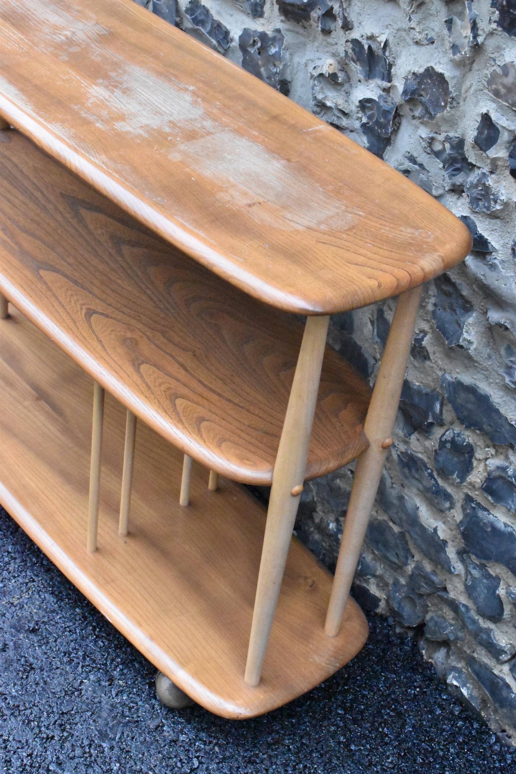 A mid 20th century Ercol elm and beech Baby Giraffe three tier trolley, model 361, Windsor range, - Image 4 of 5