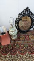 A late 20th century Chinese table lamp fashioned as a vase and a black plastic framed mirror