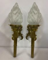 A pair of mid 20th century brass wall lights with frosted glass shades Location: