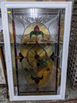 A stained glass panel in a white painted wooden frame 148cm x 90cm Location: