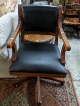 A mahogany and leather upholstered swivel office chair with loose cushion set Location: