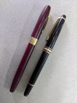 A Montblanc - Meisterstuck black pen and a brown Sheaffer with a 14k gold nib, marked D.P.P on the