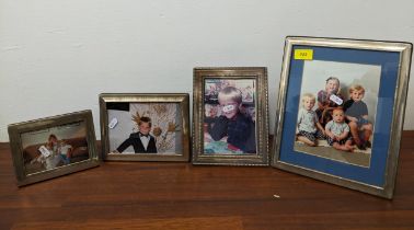 A group of four silver photograph frames, mixed dates, makers mark from Harrods Ltd Location: