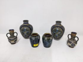 A group of three pairs of Doulton Lambeth stoneware vases to include a pair of ovoid shaped vases