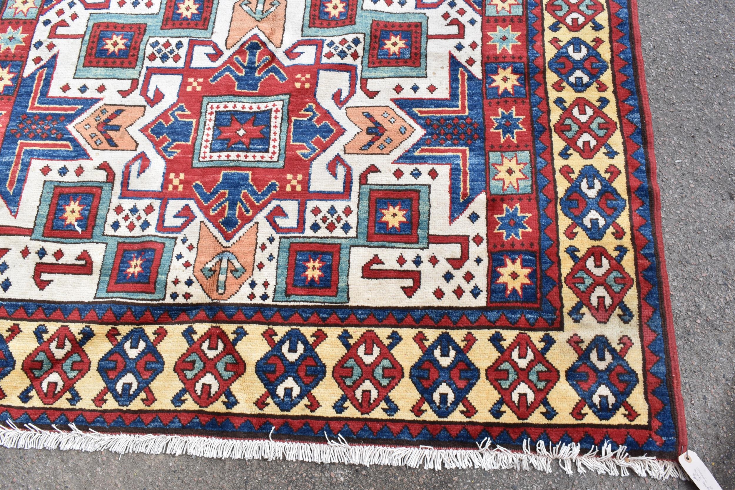 A handwoven Caucasian star kazak rug, having a geometric designs with repeating motifs, multiguard - Image 2 of 8