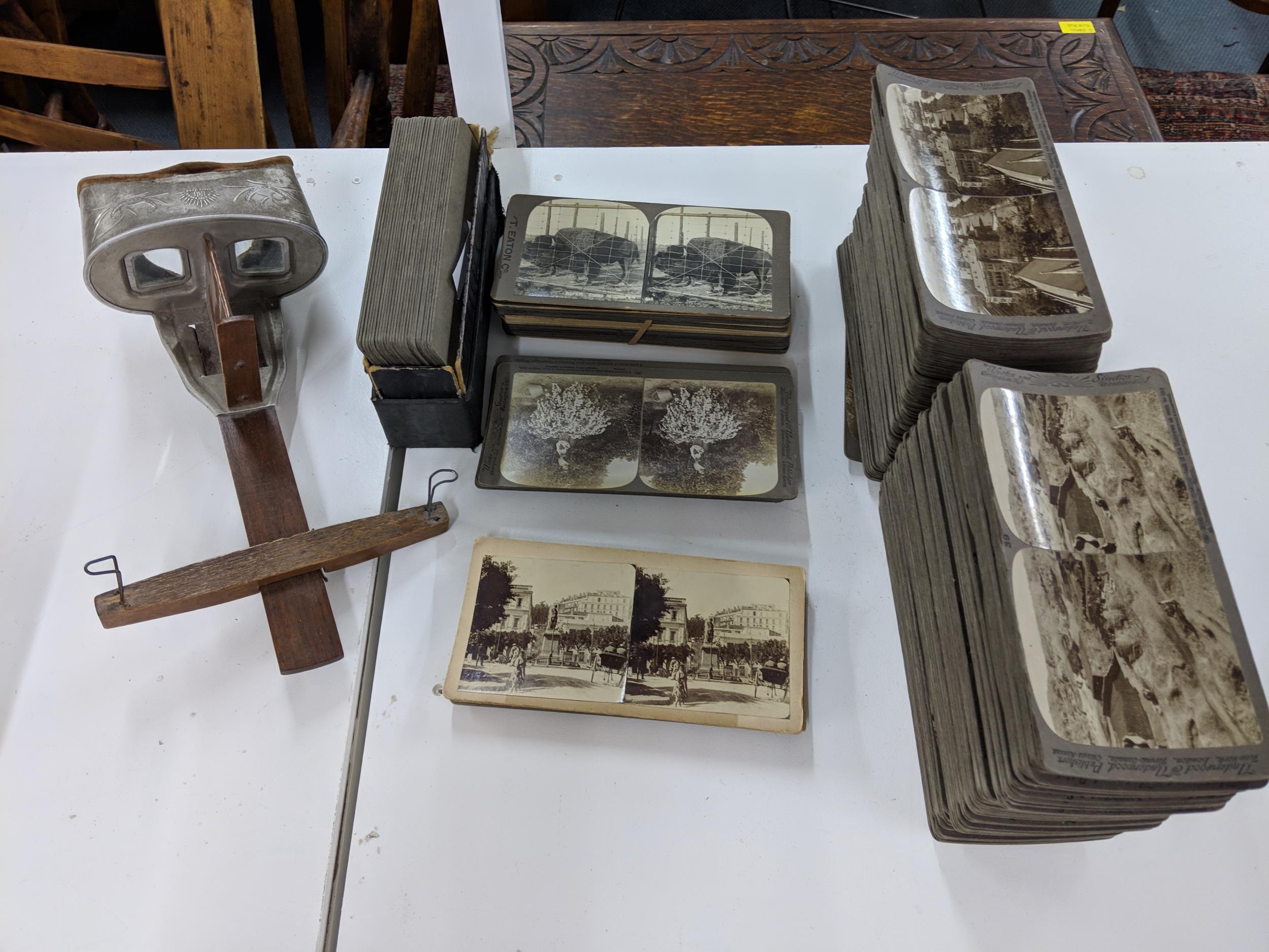 An underwood stereoscope and approximately two hundred and sixty four photographic cards to