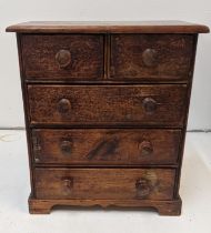 A 19th century pine apprentice chest of drawers with turned handles, on bracket feet Location: