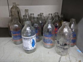 A group of vintage glass milk bottles, some from local dairies, to include Stokes Dairy Camberley