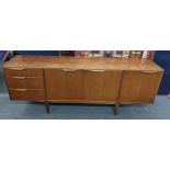 A mid 20th century McIntosh teak sideboard having a fall flap, two cupboards and three drawers, 76.