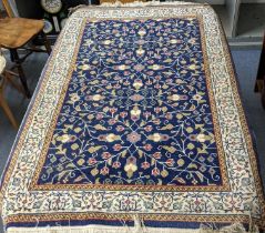 A Turkish rug with flowering vines on a blue ground 148cm x 94cm Location: