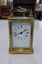 A mid 20th century carriage clock, swing handle faced with a Roman dial Location: 6:3