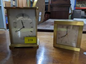 A Tiffany & Co brass cased alarm clock, and a Garrard brass cased quartz mantel clock, both with