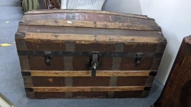 A Victorian domed top steamer trunk, canvas bound with wrought iron supports, 52cm h x 83cm w