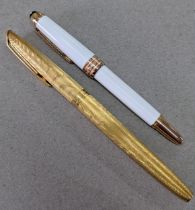 A Montblanc Meisterstuck white fountain pen, stamped 750 on the nib and a gold coloured Waterman,