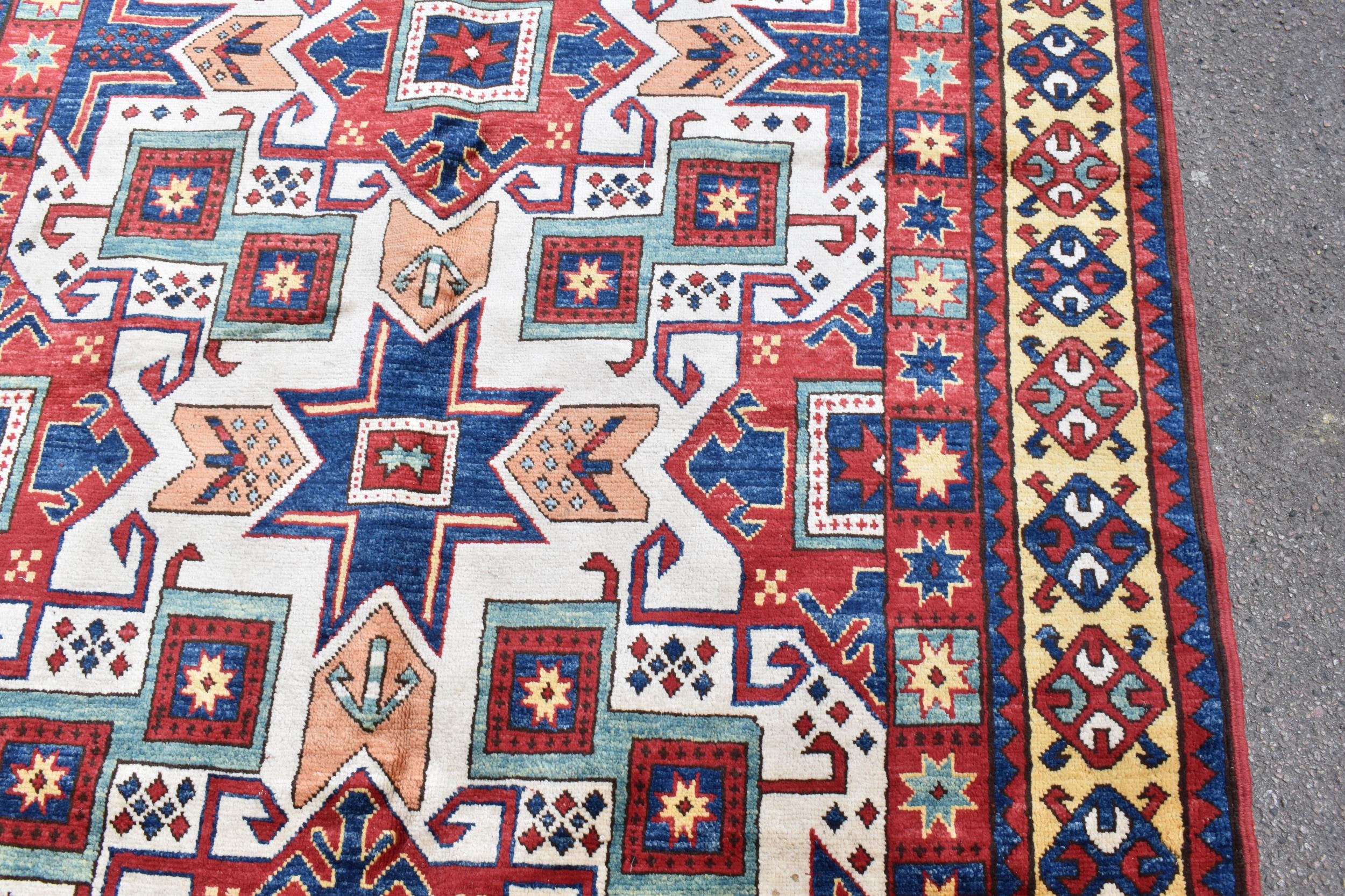 A handwoven Caucasian star kazak rug, having a geometric designs with repeating motifs, multiguard - Image 3 of 8