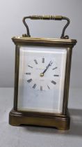 A Matthew Norman brass cased carriage clock with swing handle Location: