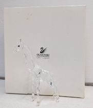 A boxed Swarovski model of a giraffe Location: