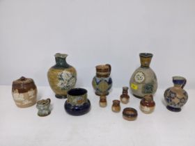 A selection of Doulton stoneware to include a jug decorated with a curled dragon and two flower