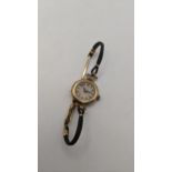 A 9ct gold ladies manual wind wristwatch A/F, on a fabric bracelet and a clasp, total weight, 17/6g,