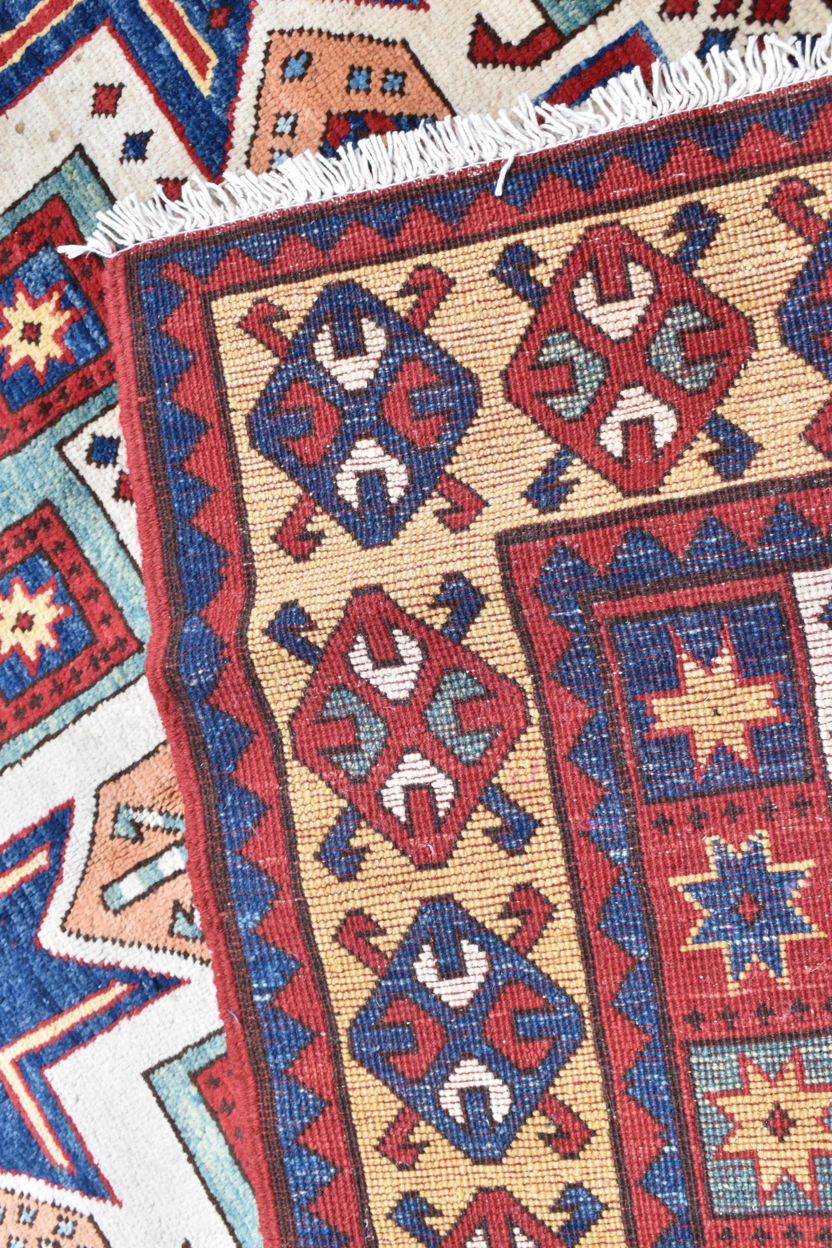 A handwoven Caucasian star kazak rug, having a geometric designs with repeating motifs, multiguard - Image 8 of 8