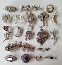 A group of vintage silver tone brooches having white crystals and paste stones together with an