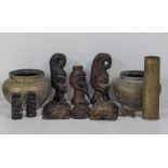 A pair of early 20th century brass plant pots, an engraved gun shell and cared African busts and